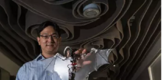 Soon-Jo Chung, associate professor of aerospace and Bren Scholar at Caltech, holds the Bat Bot.