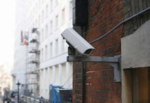 Closed-circuit television (CCTV) camera at rear of building in London street