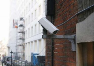 Closed-circuit television (CCTV) camera at rear of building in London street