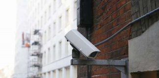 Closed-circuit television (CCTV) camera at rear of building in London street