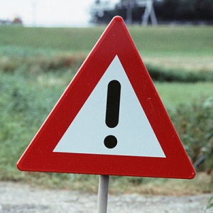 Hazard warning sign by country roadside, close-up